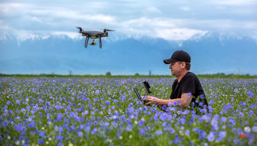 https://www.preflight.co.il/wp-content/uploads/2021/12/man-operating-flying-drone-quadrocopter-green-field.jpg