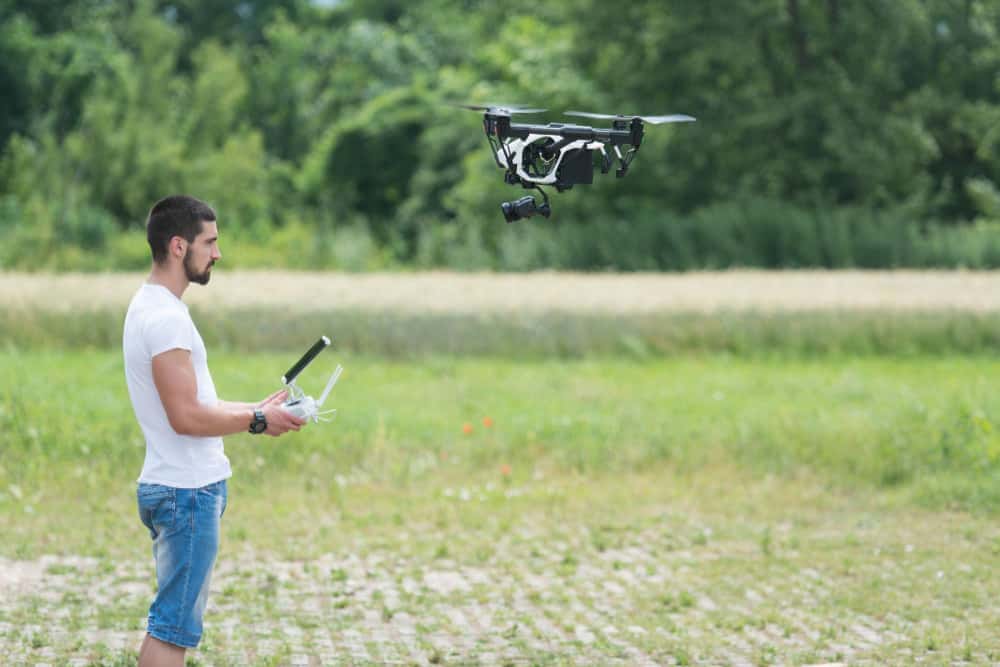 https://www.preflight.co.il/wp-content/uploads/2022/06/man-operating-drone-flying-hovering-by-remote-control-nature-1.jpg